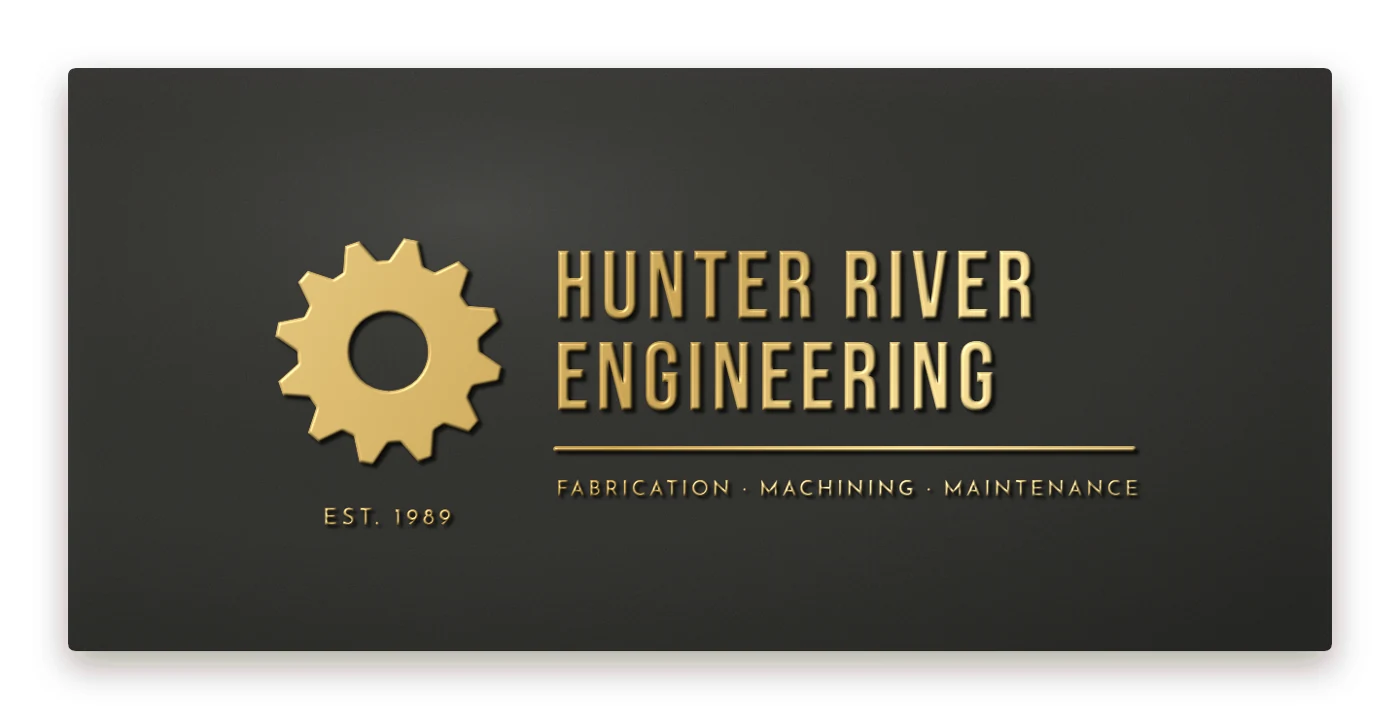 Embossed design idea: modern business name plaque with a raised gear logo, brass on smooth black
