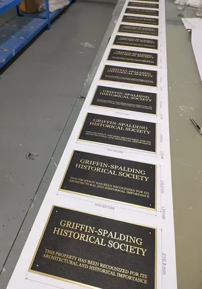 Set of matching embossed historical society plaques