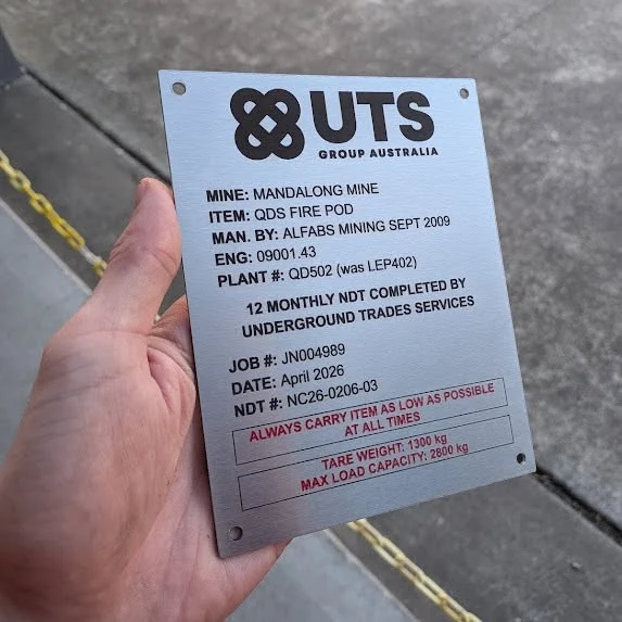 Engraved stainless steel mine equipment data plate with job, plant and load capacity details