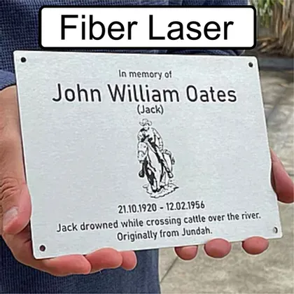 Fibre laser engraved memorial plaque with a horse emblem, held in hand