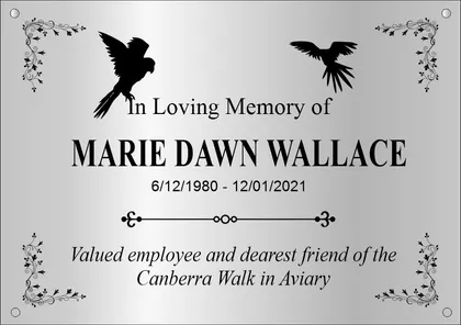 Garden memorial plaque with birds