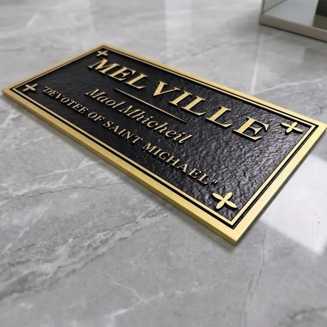 Embossed plaque with raised gold lettering and corner crosses