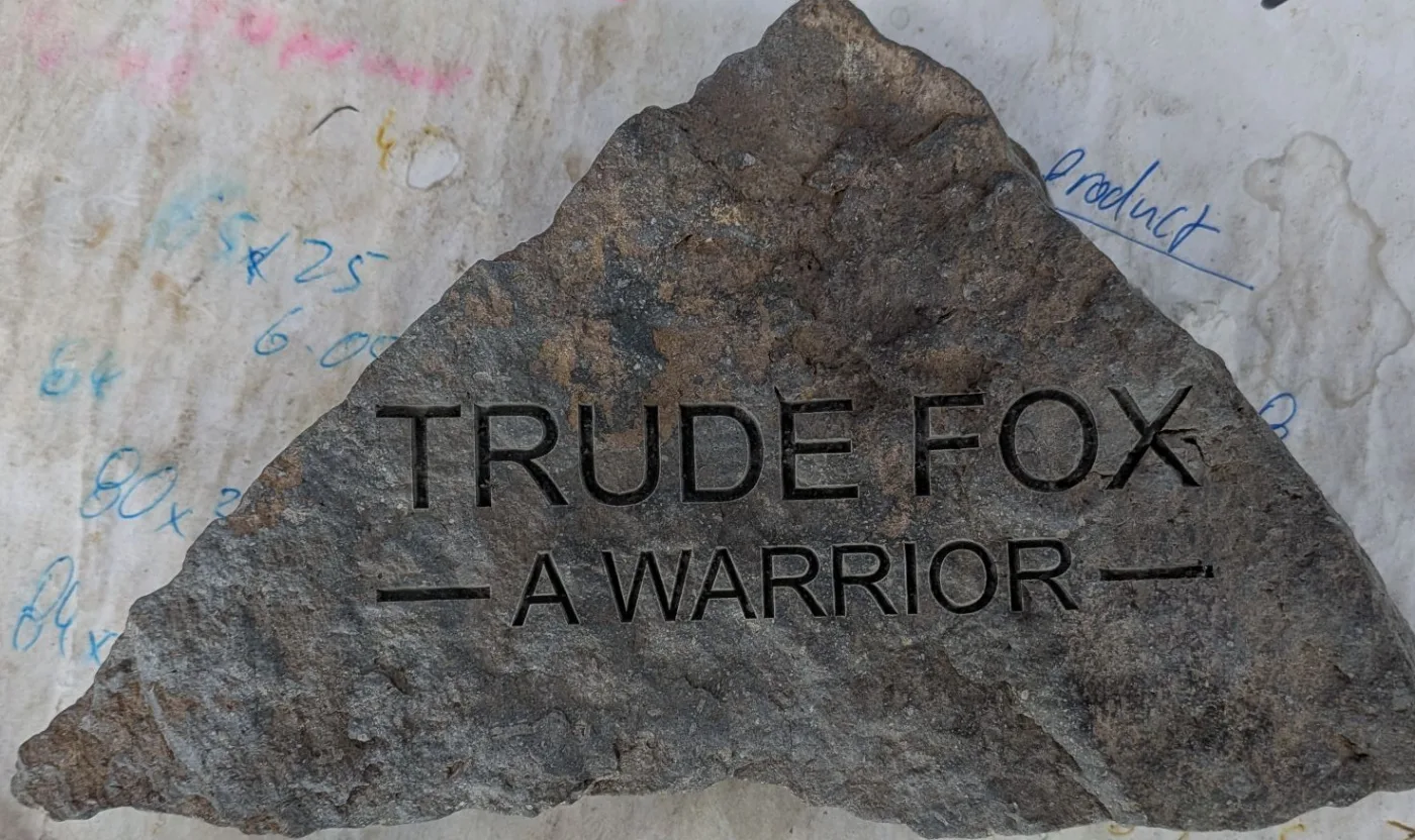 Name laser engraved into a natural stone as a memorial