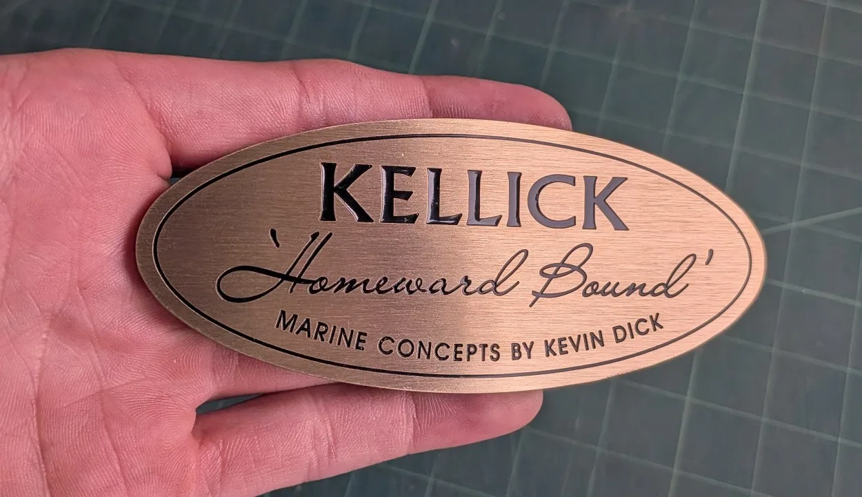 Oval brass builder's plate with black paint filled lettering