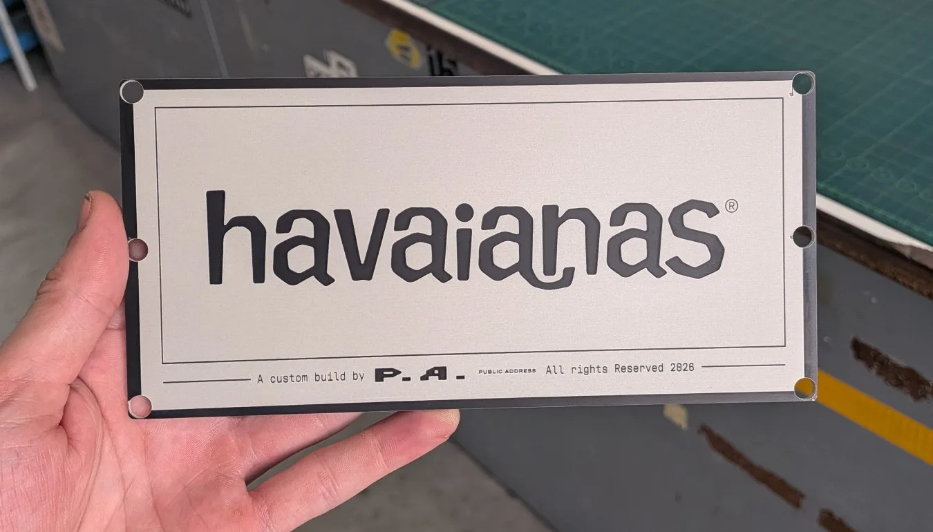 Stainless steel brand plate with a black engraved logo