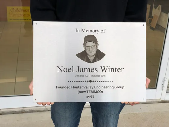 Stainless steel memorial plaque with an engraved portrait, name, dates and a short tribute line